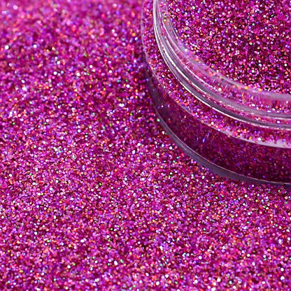 Close-up of pink glitter with a clear container on a pink glitter background