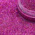 Close-up of pink glitter with a clear container on a pink glitter background