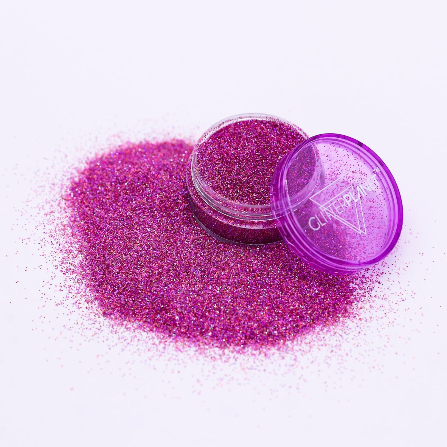 Purple glitter with a open container on a white background