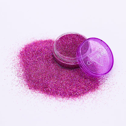 Purple glitter with a open container on a white background