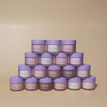 Stack of NM skincare jars on a beige background