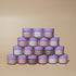 Stack of NM skincare jars on a beige background