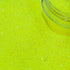 Close-up of bright yellow glitter with a clear container partially filled with glitter.