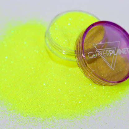 Neon yellow glitter with a purple container labeled &