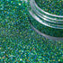 Green glitter with a clear container partially filled with glitter