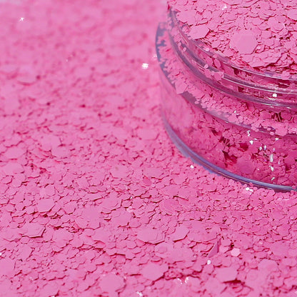 Pink glitter in a clear jar spilled out.