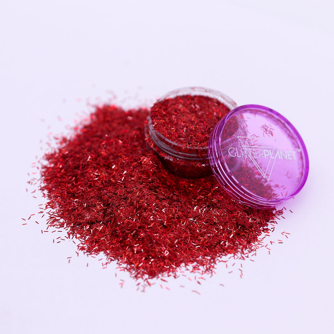 Red glitter with a purple lid on a white background