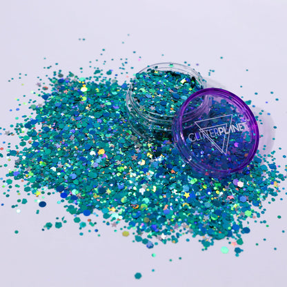 Turquoise glitter with a purple lid container on a white background