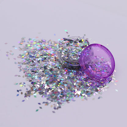 silver holo glitter container with scattered glitter on a light gray background