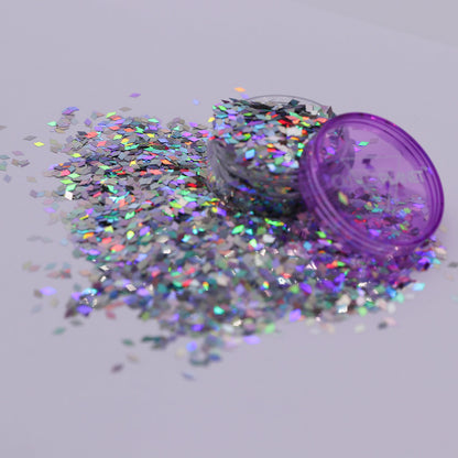 Jar of glitter with scattered holo diamonds on a light gray background