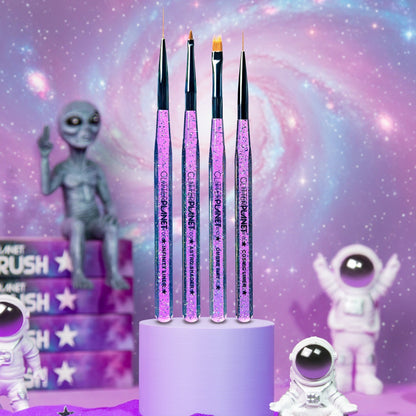 Set of nail art brushes on a stand with space-themed background featuring alien figures.