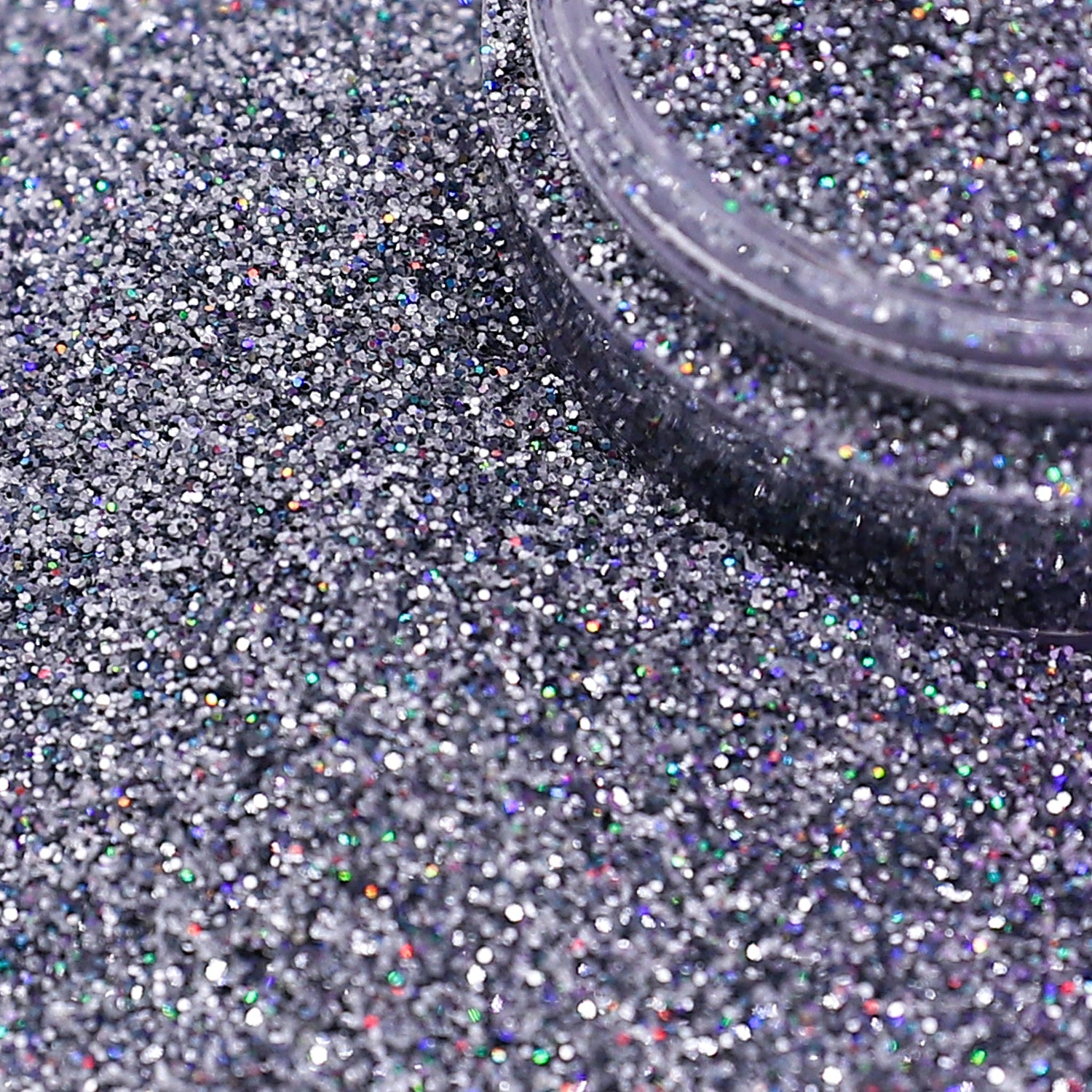 Silver glitter with a container on a textured surface