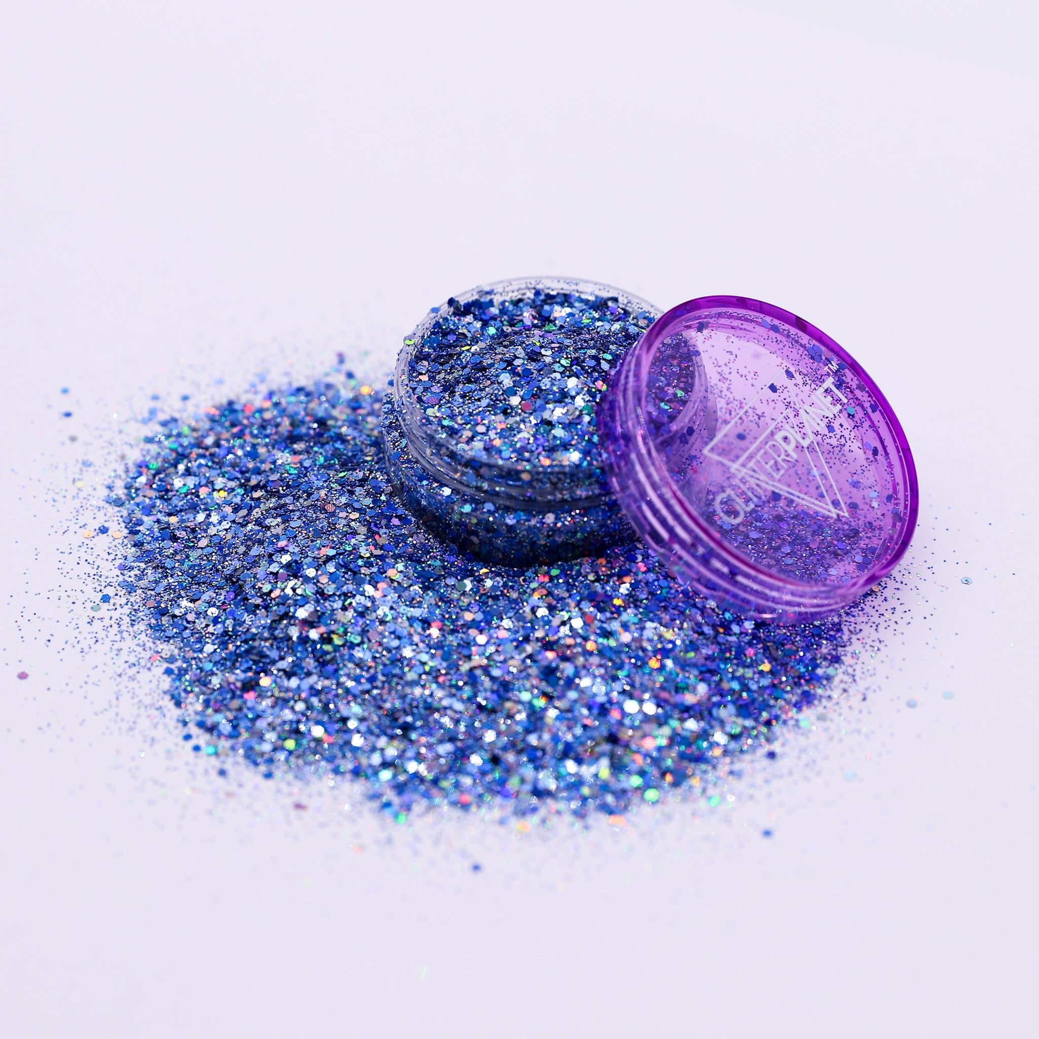 Blue glitter with a purple lid on a white background