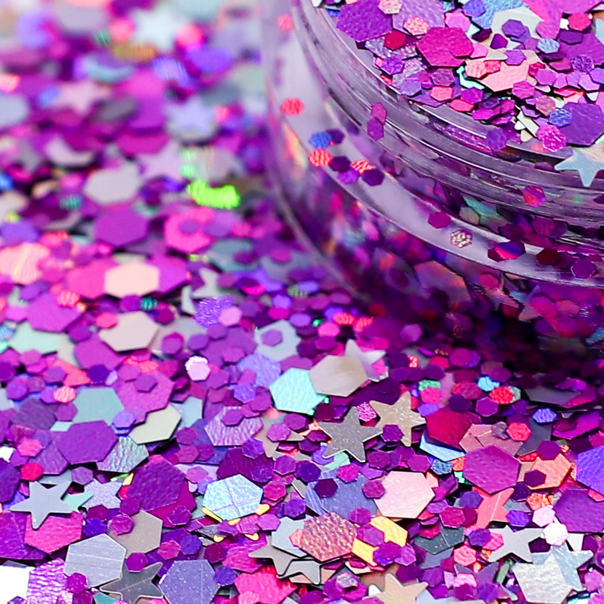 Colorful star-shaped glitter with a container in the background