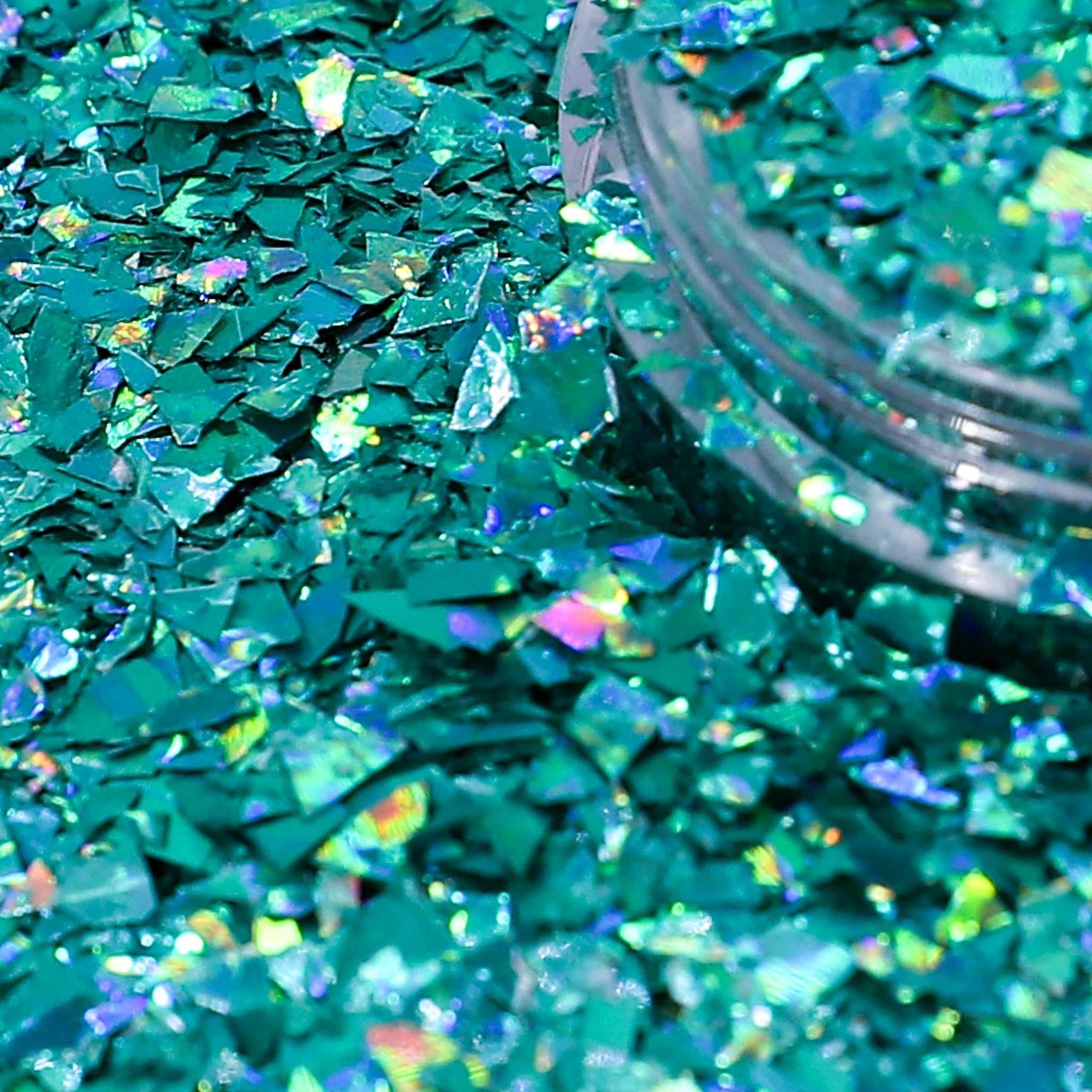 Turquoise glitter with a jar of glitter in the background