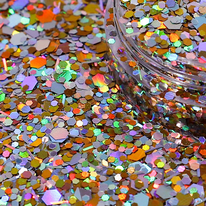 Multicolored glitter on a dark background with a container of glitter.