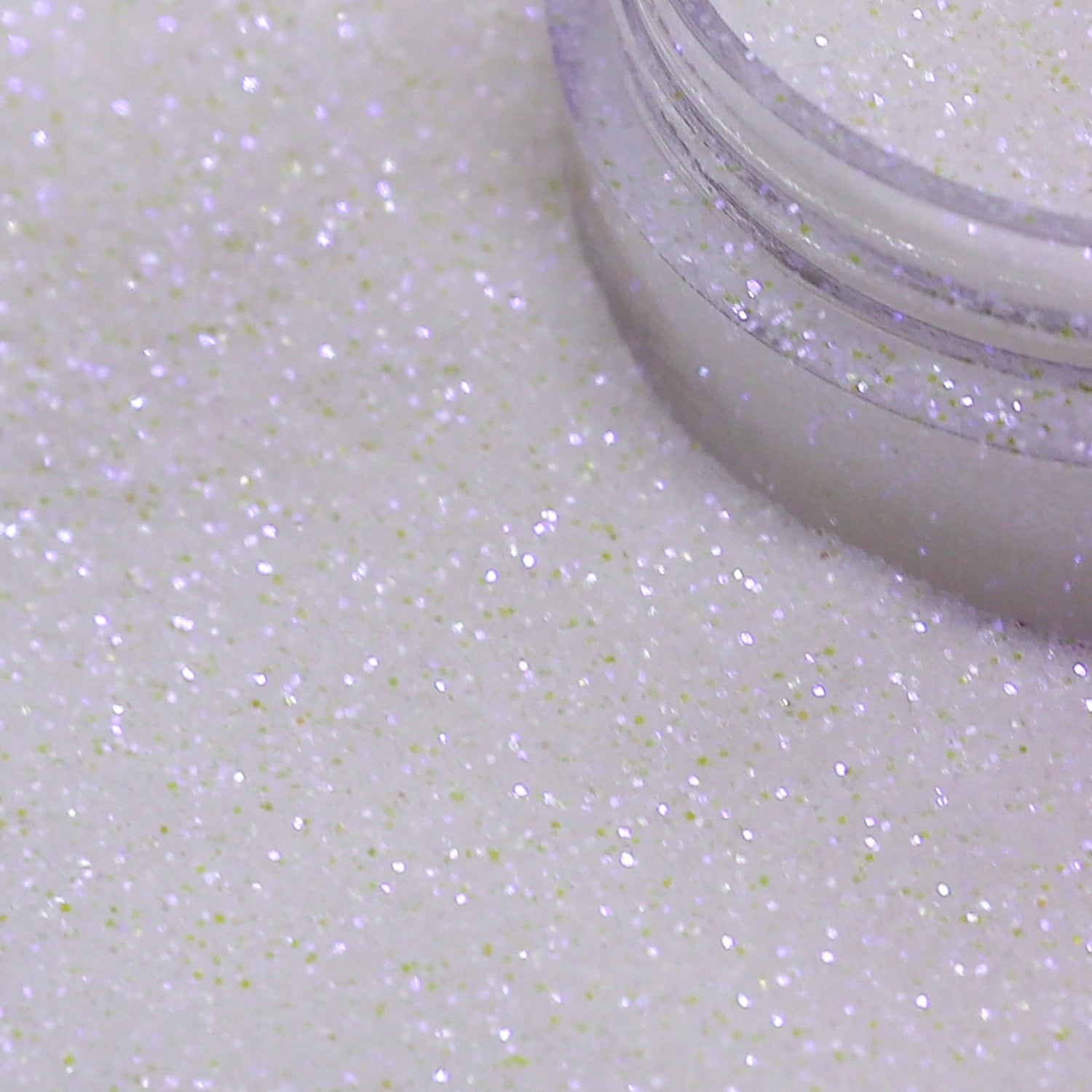 Close-up of a container of white glitter on a white background | Glitter Planet