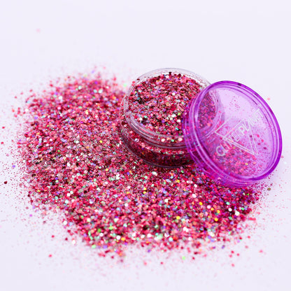 Pink glitter with a purple container on a white background