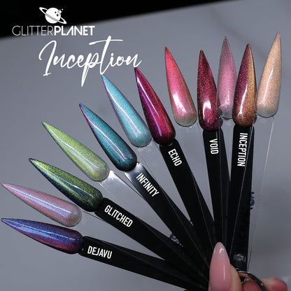 A fan of glitter nail polish samples on black swatch sticks held by a hand, with the brand name Glitter Planet and the shade name Inception visible. The shades include holographic pink, teal, green, lavender, blue, and rose gold.