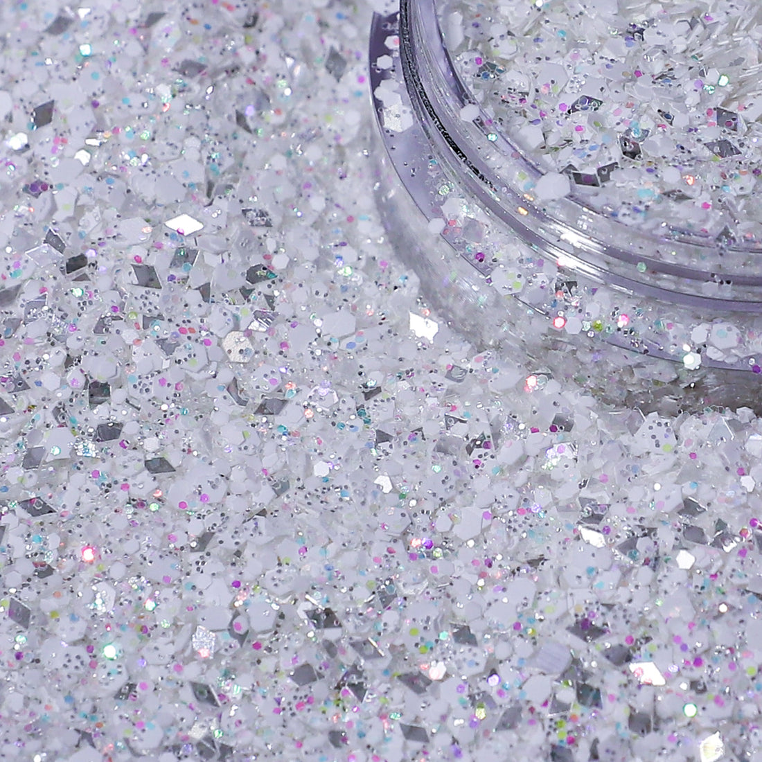 Close-up of a container of silver glitter on a white background