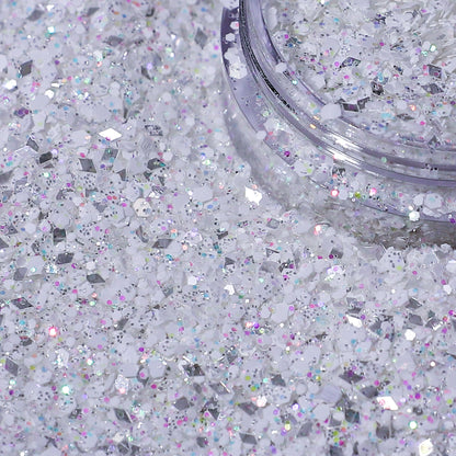 Close-up of a container of silver glitter on a white background