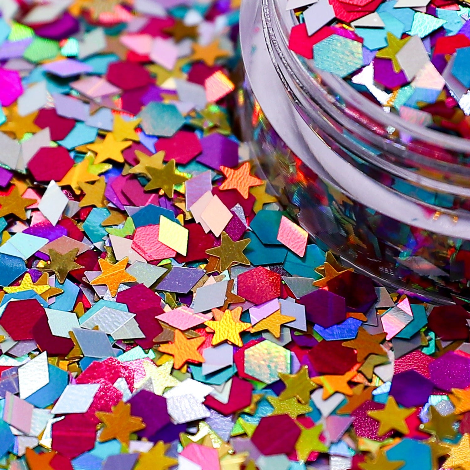 Colorful star-shaped confetti with a container in the background | Glitter Planet